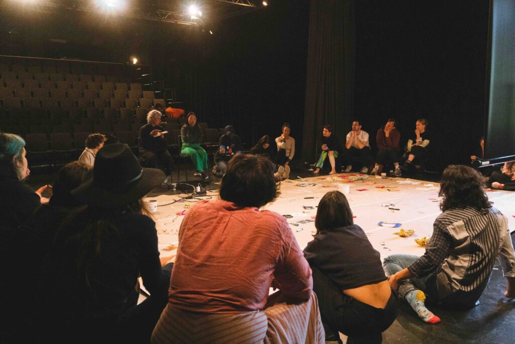 group researches different ways to enhance experiences of care and sustainability.
people in a circle with objects in between them