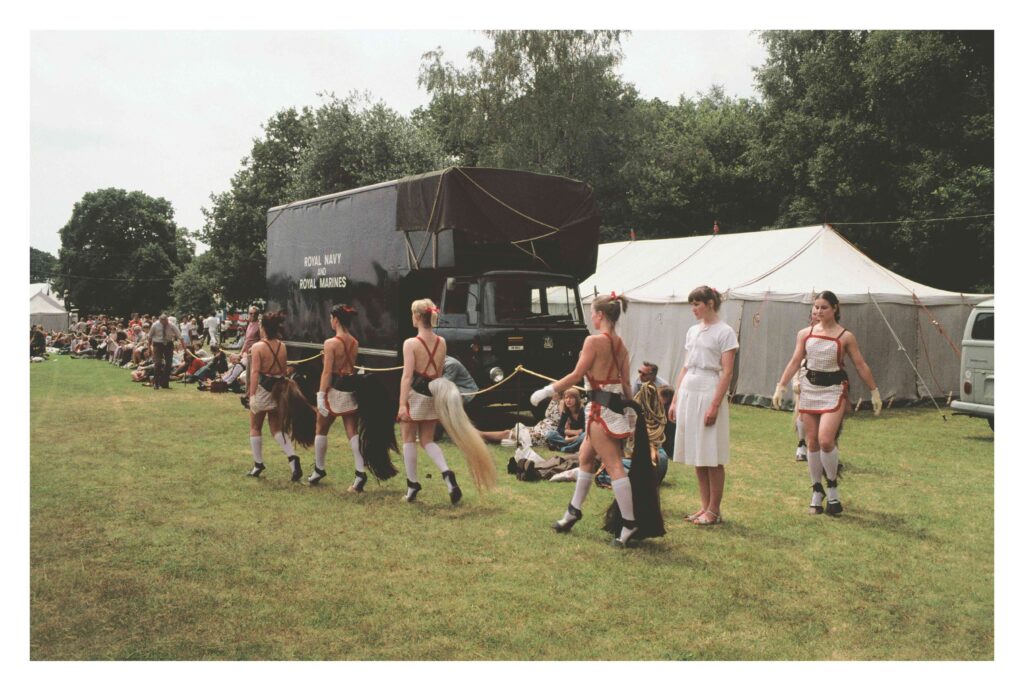 People with horse tails and high heals walking in a queu
Quadrille (Rose and Dancers Entering). L to R: Judith Katz, Helen Crocker, Sally Cranfield, Joanna Bartholomew, Rose English, Maedée Durpès, Jacky Lansley.