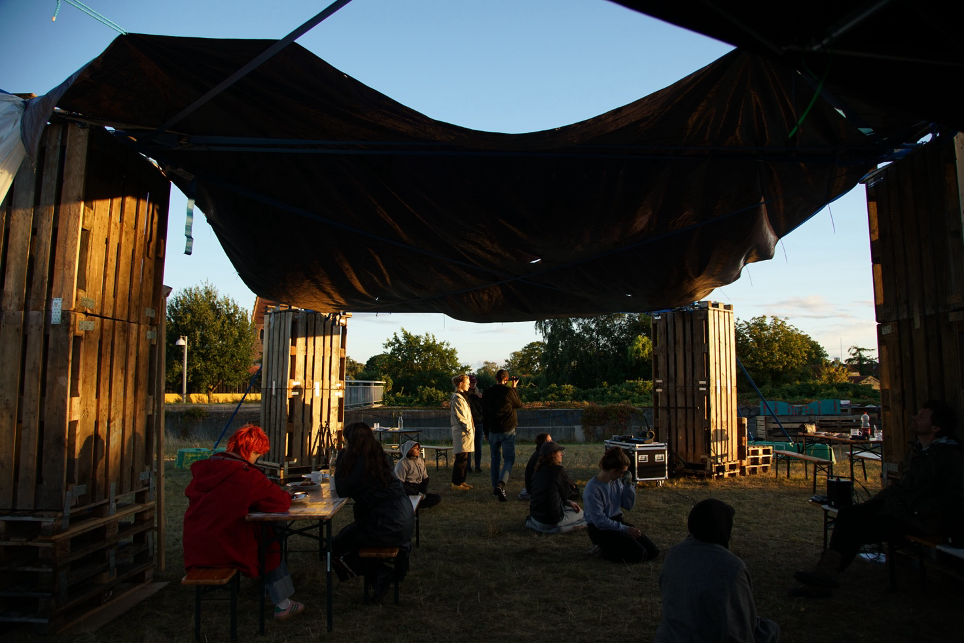 people hanging out in a outside space with low light. looks calm - Økocity 2.0